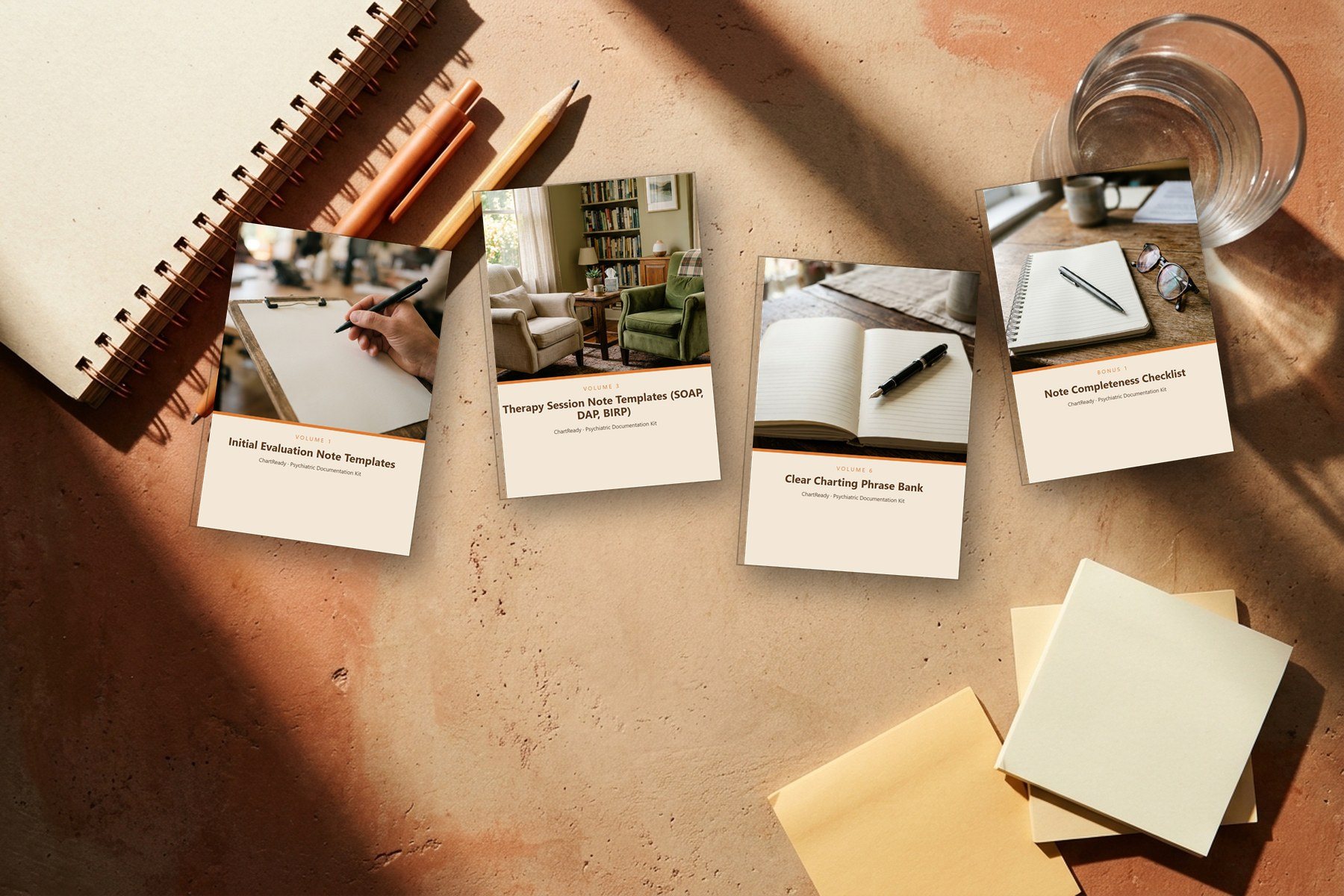 Covers of the ChartReady kit laid flat on a warm desk with pens and a notebook